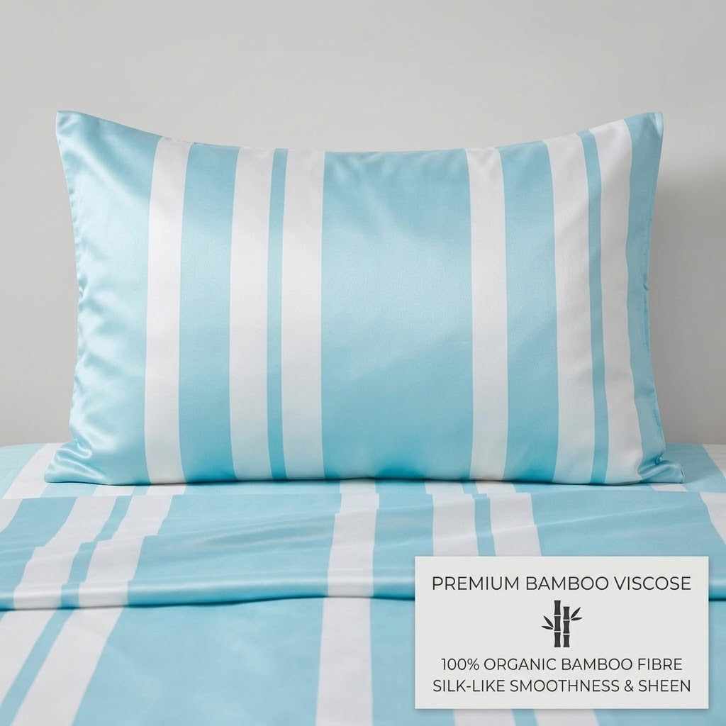 A light blue and white striped pillowcase displayed on a matching bed sheet, with a white text overlay in the bottom right corner reading 'PREMIUM BAMBOO VISCOSE 100% ORGANIC BAMBOO FIBRE SILK-LIKE SMOOTHNESS & SHEEN'.