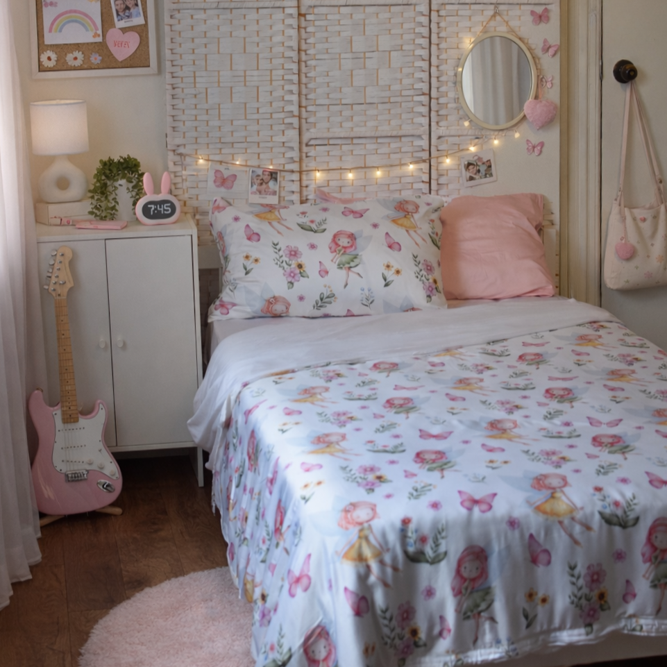 Fairy themed duvet cover set in a girl's bedroom with a pink guitar and fairy lights.