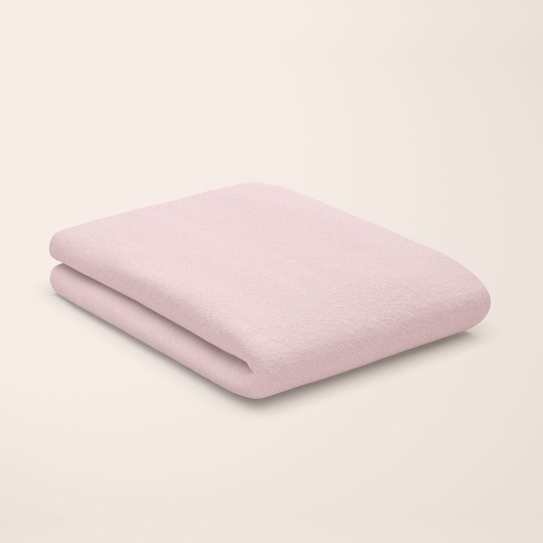 rose quartz pink flat sheet styled on kids bed setup