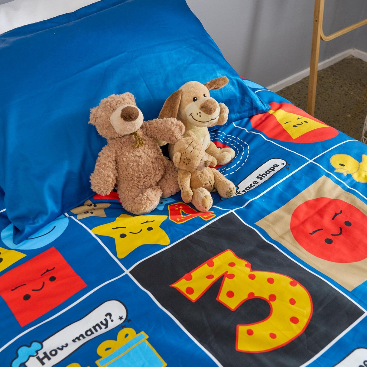 Children's maths themed duvet cover set with toys on a bed