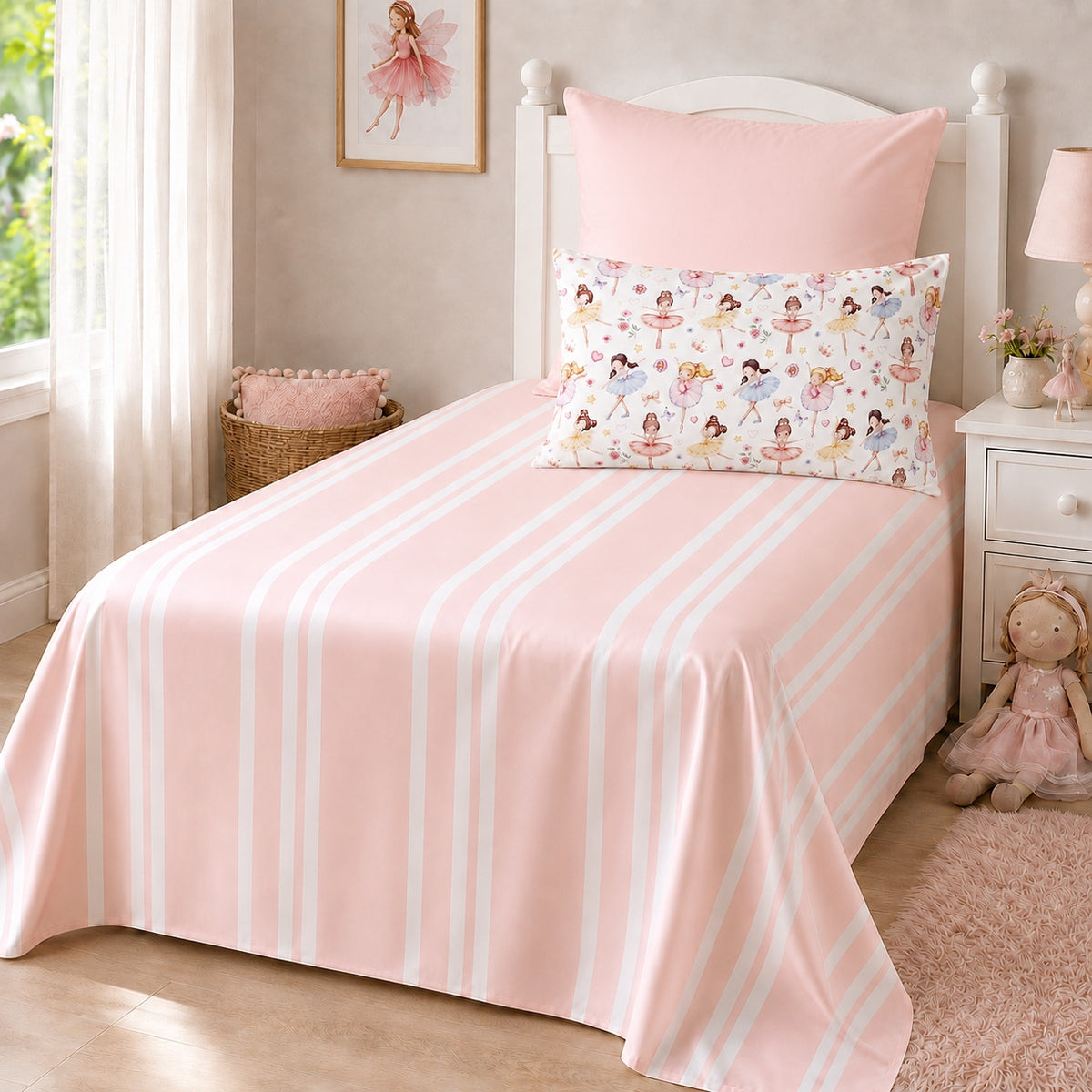 A single bed dressed in a light pink striped sheet set with a matching pink continental pillowcase and a decorative ballet patterned pillow, shown in a softly styled children's bedroom.