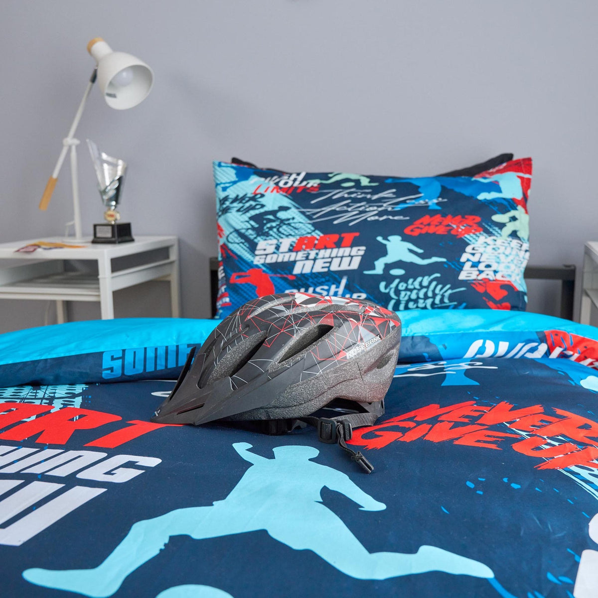 Kids sports bedding set styled with sports gear and bicycle helmet