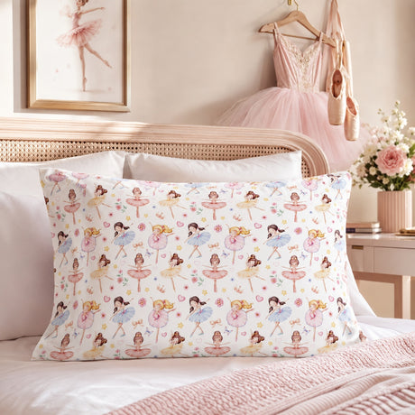 A rectangular kids pillowcase with a repeating ballet dancer pattern, styled on a bed in a soft pink bedroom setting.