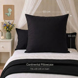 A black continental pillowcase displayed on a bed, shown with white bedding, a black textured throw blanket, and dimension markers indicating a 65 cm by 65 cm size. Text at the bottom reads 'Continental Pillowcase' and 'Fits a 65 x 65 cm insert'.