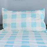 Checkered bedspread with blue and white pattern on a gray background