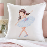 A contintental white throw pillow featuring a watercolor illustration of a young ballerina in a light blue tutu with a pink bow, styled on a bed with a pink tufted headboard and soft pink bedding.