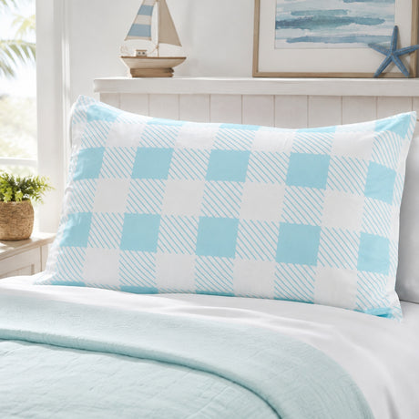 A light blue and white checkered pillow sham on a bed with a matching light blue quilt, styled in a bright bedroom setting.