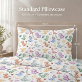 A colorful dinosaur-print kids pillowcase and matching duvet cover displayed on a bed, with overlaid text and dimension arrows showing a standard size of 45 x 70 cm.