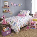 Girl's bedroom with dinosaur-themed bedding and toys on a wooden floor.