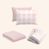 rose quartz pink gingham bamboo bedding bundle styled on kids bed setup