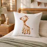 A white continental pillow featuring a watercolor-style brown giraffe illustration, styled on a bed in a warm, rustic bedroom setting.