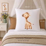 A white continental pillowcase featuring a cute cartoon giraffe design, displayed on a bed with dimension arrows indicating a 65 cm by 65 cm size. The scene is styled with a beige canopy, brown pillows, and a textured beige blanket.