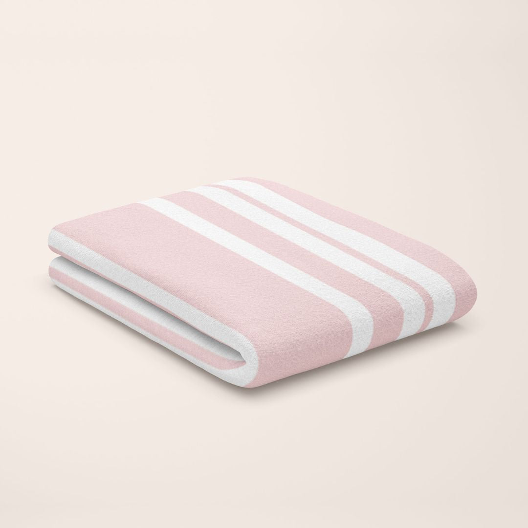 rose quartz pink & white stripe bamboo flat sheet styled on kids bed setup
