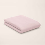 rose quartz pink flat sheet styled on kids bed setup