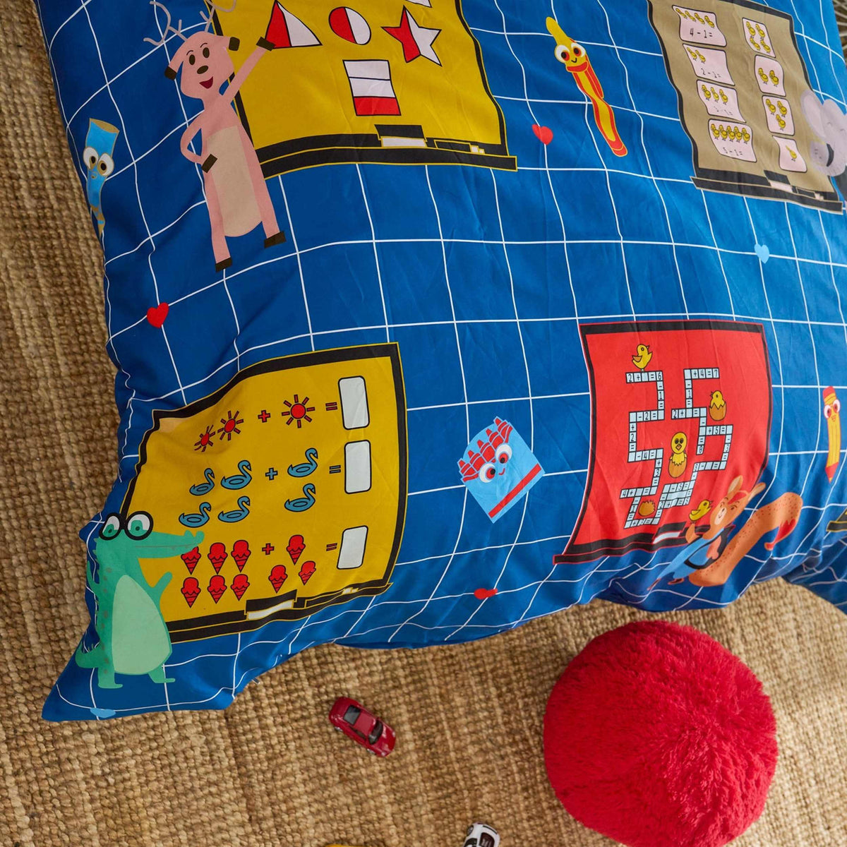 Colourful children's  maths themed duvet cover corner with cartoon designs on a textured surface. Jo's Dreamland family designed organic kids bedding South Africa
