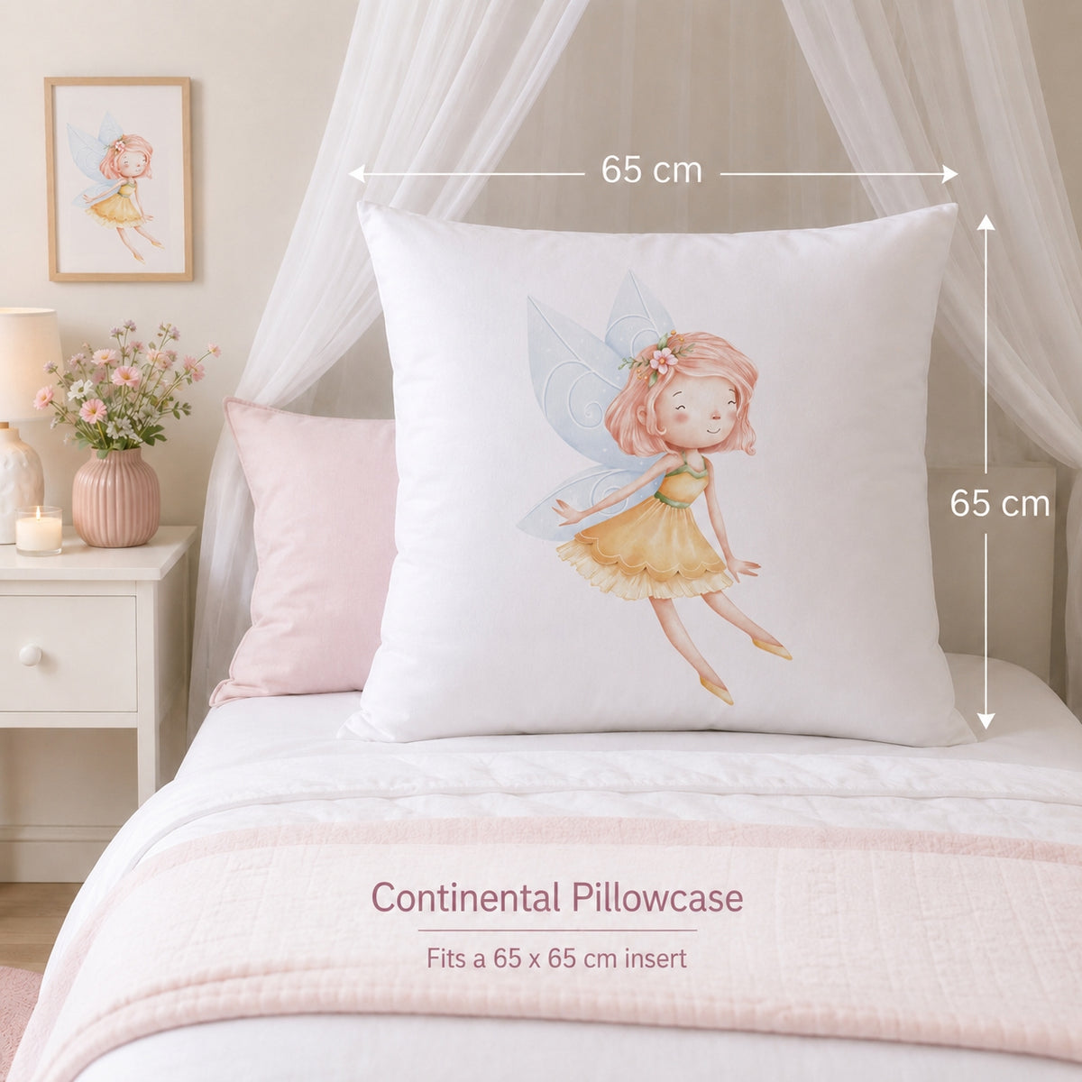 A large white Continental Pillowcase featuring a watercolor fairy illustration, shown on a bed with dimension markers indicating a 65 cm by 65 cm size. The scene includes a pink accent pillow, a bedside table with flowers, and soft white canopy drapes.