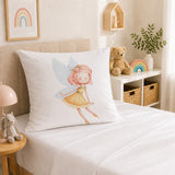 A white continental pillowcase featuring a watercolor illustration of a fairy with pink hair and a yellow dress, displayed on a bed in a softly styled children's bedroom.