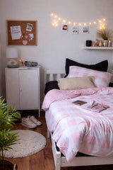 Cozy bedroom with pink and white check bedding, string lights, and a white cabinet. Jo's Dreamland family designed organic kids bedding South Africa