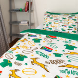 A white South Africa rugby-themed kids bedding set featuring a duvet cover and pillowcase with green, yellow, and brown sports motifs, including rugby balls, jerseys, leaping springbok jockies, and 'Go Boko!' and 'South Africa' text, styled in a bedroom setting.