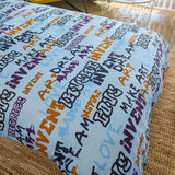 Close up of a light blue kids duvet cover on a bed.