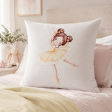 A white continental pillow featuring a watercolor illustration of a ballerina in a yellow tutu, styled on a bed in a soft, neutral bedroom setting